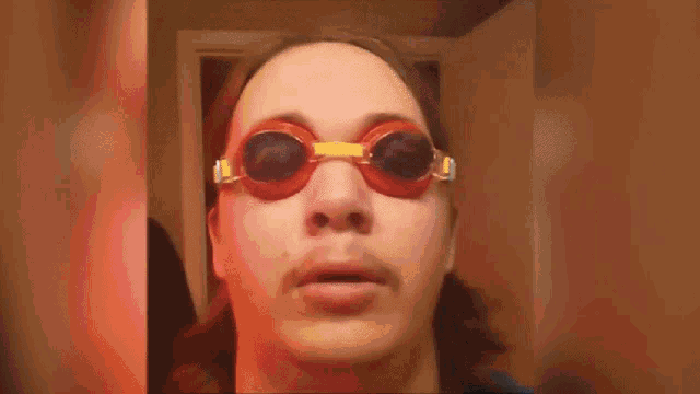 A gif of a person with a mustache and shoulder-length hair, wearing swimming goggles and a Spiderman costume. In the first frame the caption reads "It is Wednesday, my dudes." In the second frame the person stands in a doorway and screams, the caption reading "AAAAAAAAAAAAAAAAA"