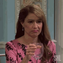 Gif of Melissa Villaseñor squeezing a wine glass so tightly with rage that it shatters in her bare hand. From an SNL skit. The camera slowly zooms in on her as she wears an expression of anger and disgust.