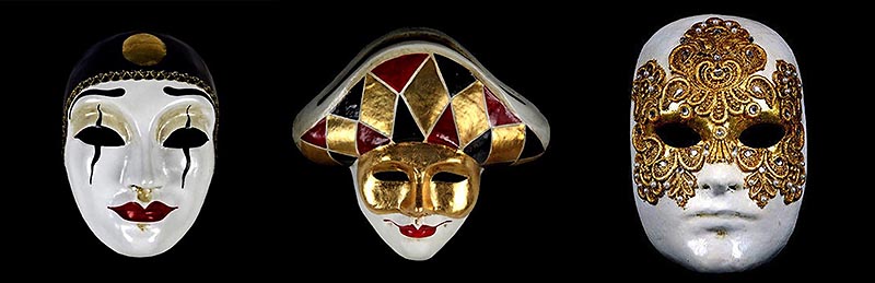 A trio of Carnevale masks. On the left is a white mask with red lips and wavy lines crossing vertically over the eyes, and a black cap shape over the forehead. In the middle, a mask with red lips and a gold mask over the eyes - this figure wears a crescent-shaped headpiece with gold, black, and red diamonds. On the left, a mask that is completely white except for a large golden filigree covering the foreheard, eyes, nose bridge, and cheeks.